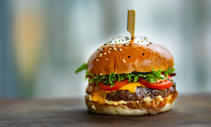 Photo of Juicy Burger on Wooden Surface