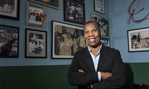Greg Dulan inside Dulan’s on Crenshaw, with historical family photos on display. (Courtesy Photo)
