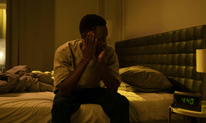 A Man Sitting on a Bed