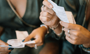 People in Twinning Outfit Holding Receipts